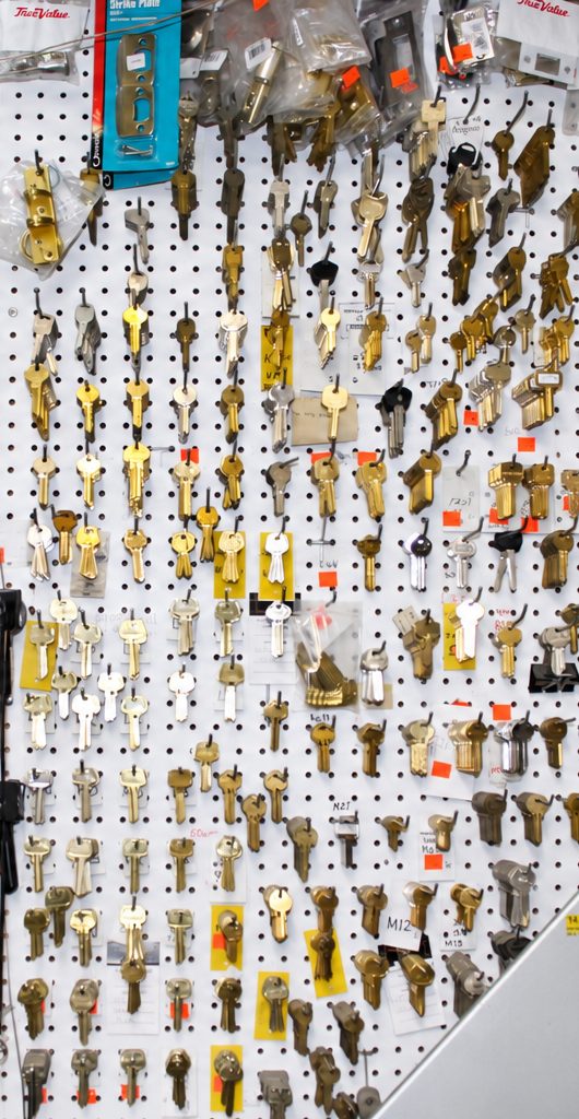 Key blanks hanging on the pegboard wall inside the shop