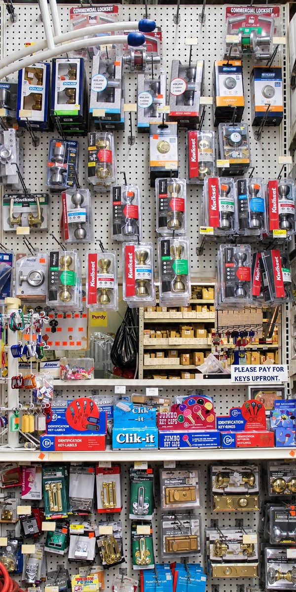 Locksets and deadbolts on the display rack inside the shop